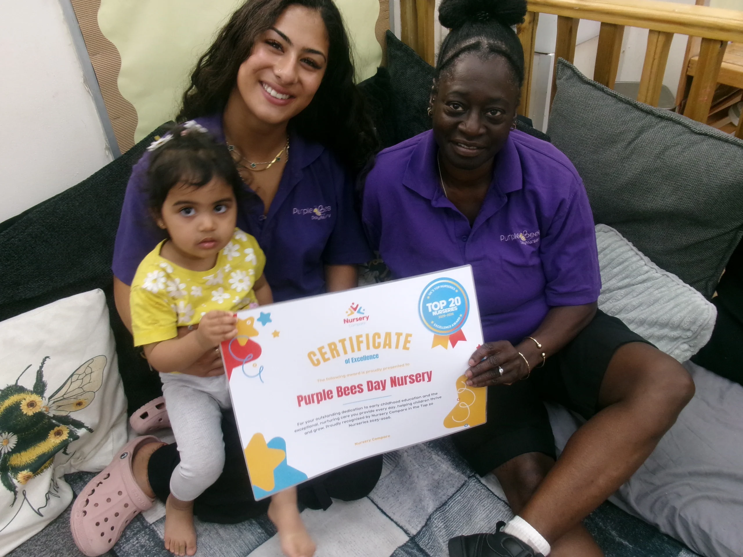 Purple Bees Day Nursery staff and children celebrating in a bright Hounslow nursery playroom